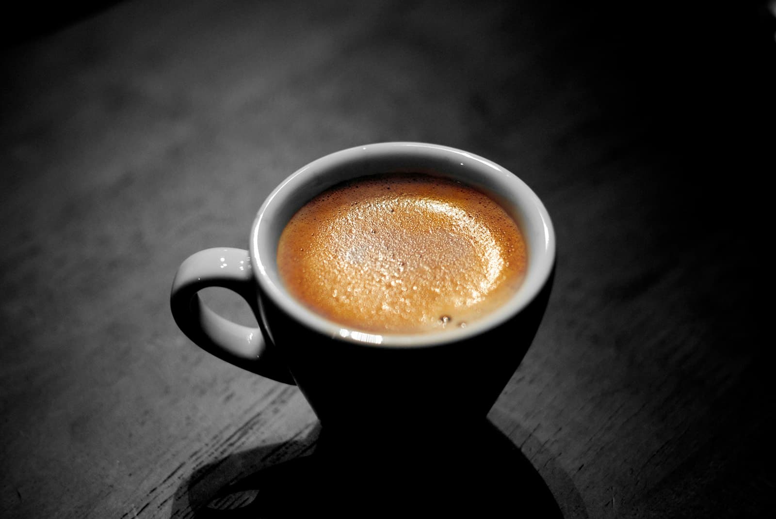 Espresso with fresh crema on a dark table